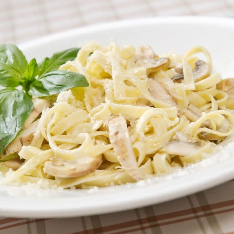 Square image of a plate of chicken alfredo.