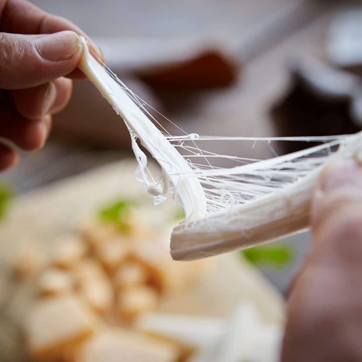 Square image of pulling string cheese.