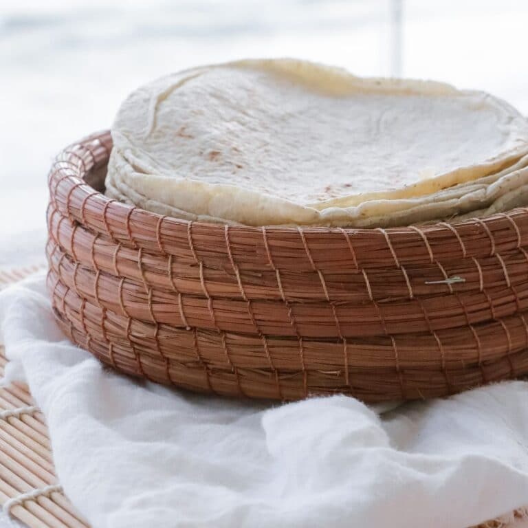 Square image of a stack of flour tortillas.