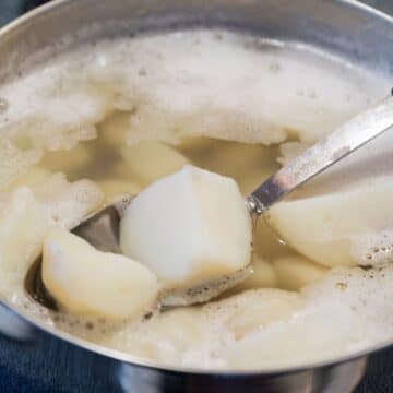 Square image of a pot of boiling potatoes.