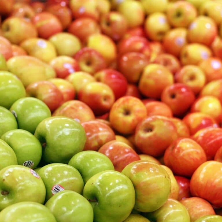 Square image of a variety of apples.