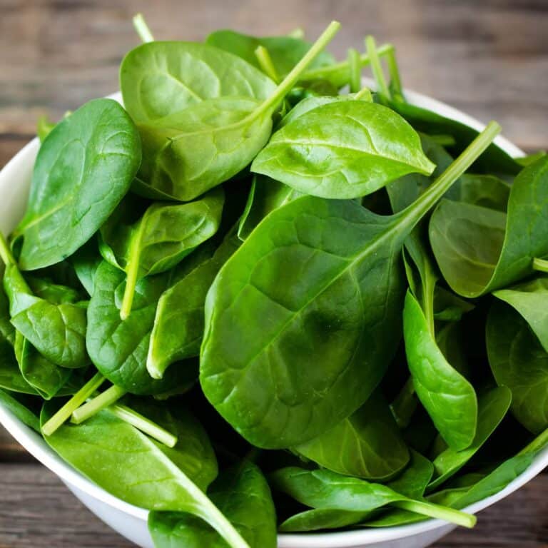 Square image of spinach in a bowl.